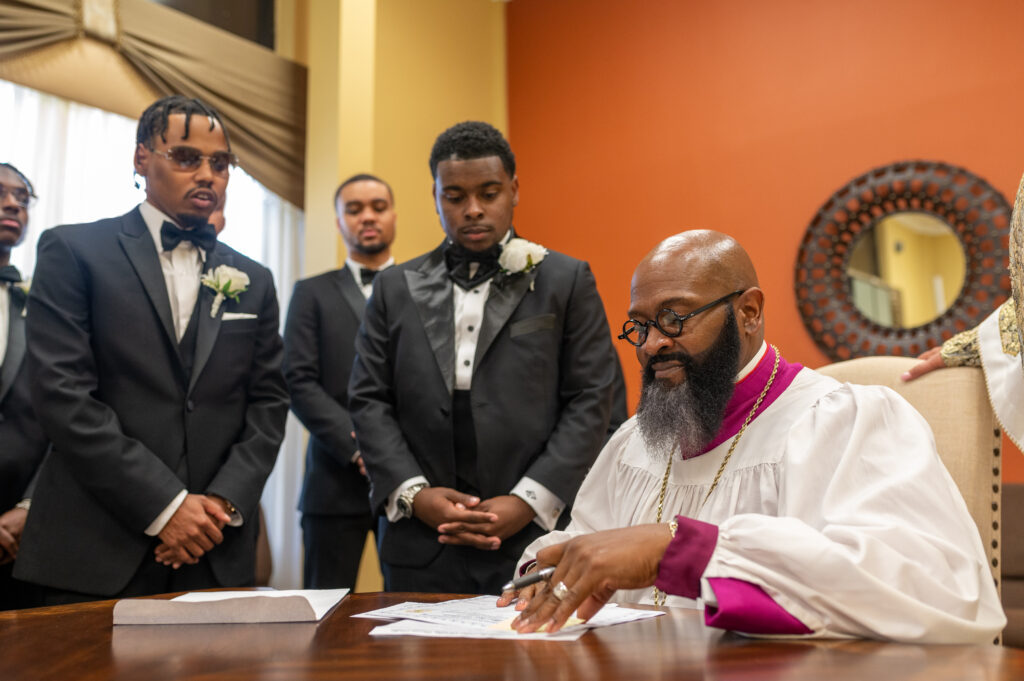 Groom and witnesses signing marriage license