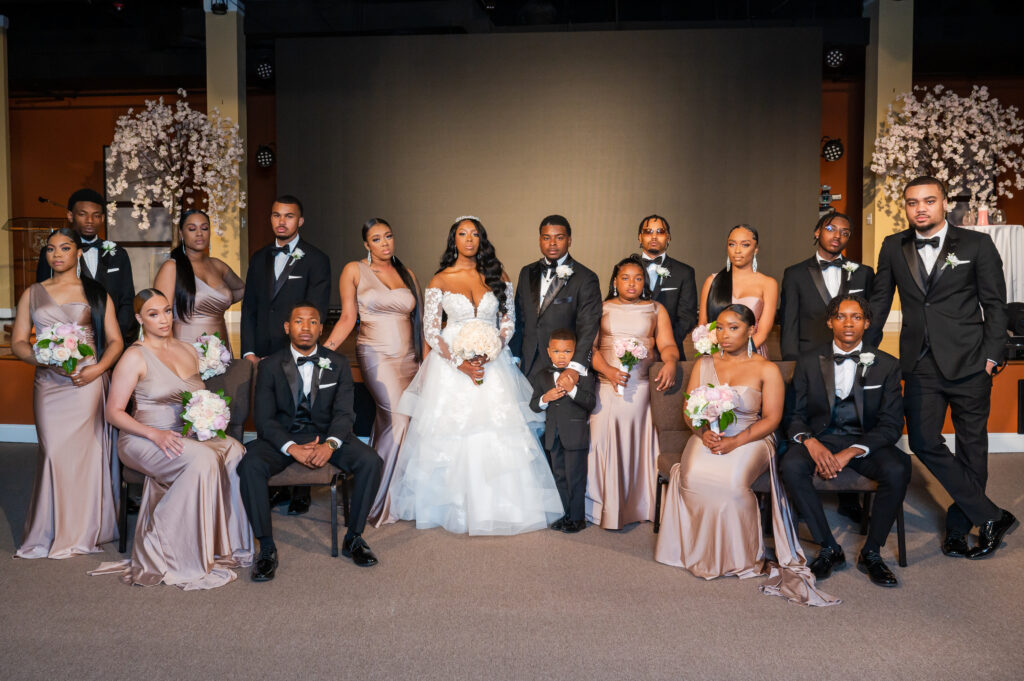 entire wedding party posing with bride and groom at the ceremony