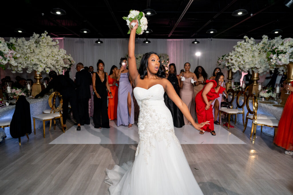 bride doing bouquet toss at The Sinclair Baltimore Wedding