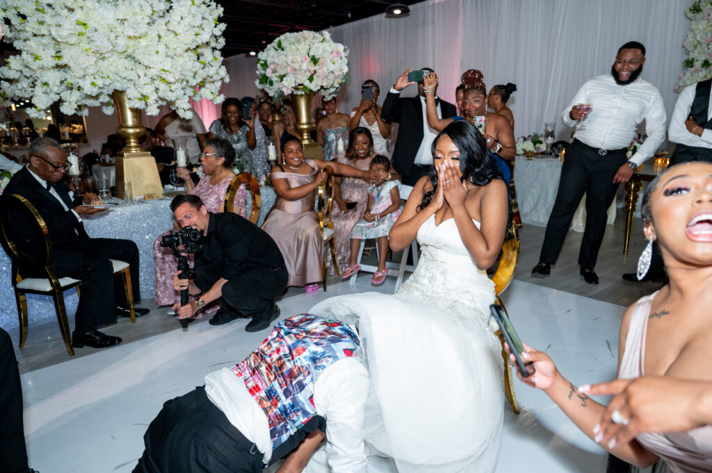 groom removing brides garter at The Sinclair Baltimore Wedding